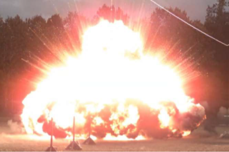 Sidewinder missile on cart shown on flight deck at sunset